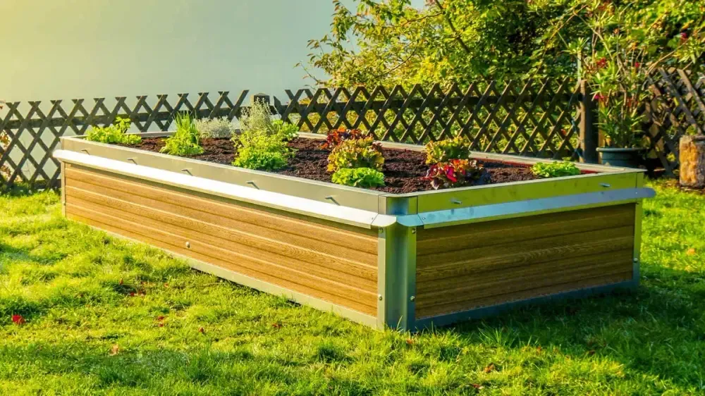 Bepflanztes Metall-Hochbeet in Holzoptik auf einer Gartenwiese